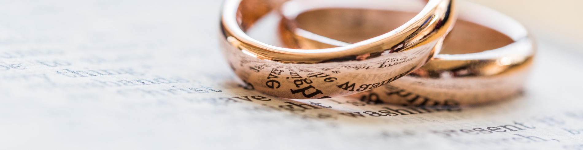 wedding bands on a book