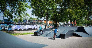 Teens on skate park structures at Joël Gauthier Park