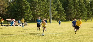 children playing soccer in park