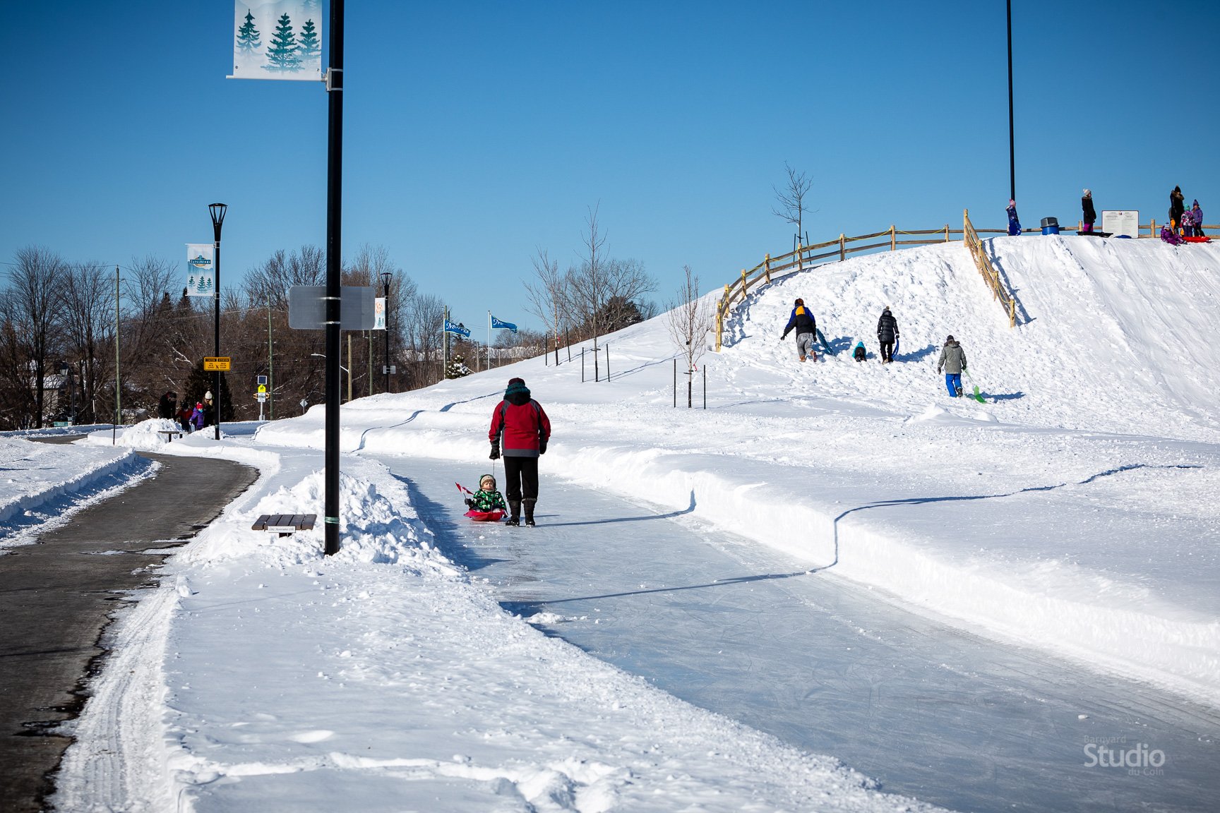 kids sledding on hill covered in snow