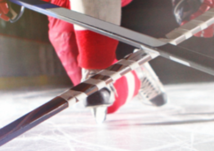 Hockey skates with crossed sticks on the ice