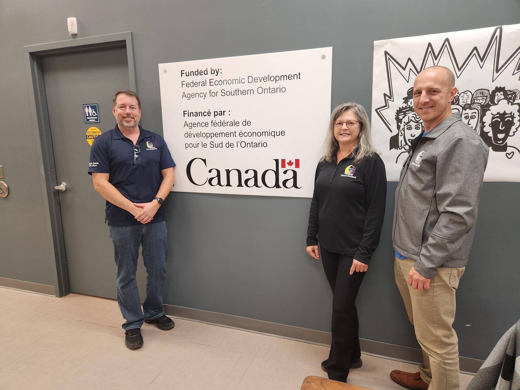 Mayor Mario Zanth, Director Jean-Luc Jubinville and Councillor Diane Choinière in front of a funding sign