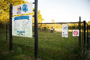 Sign on fence at the off-leash dog park