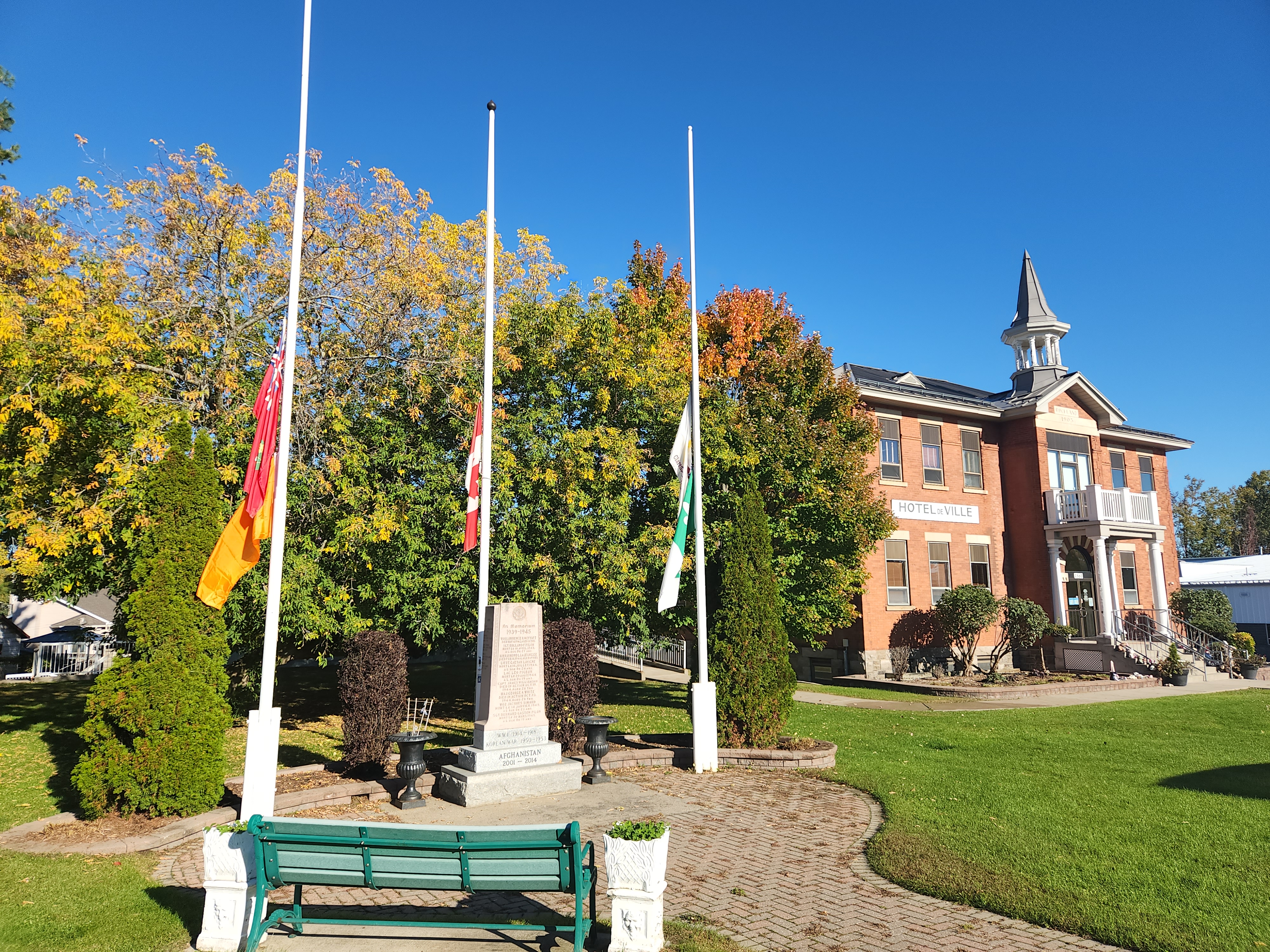 City Hall flags at half mast including an orange flag for Truth and Reconciliation Day