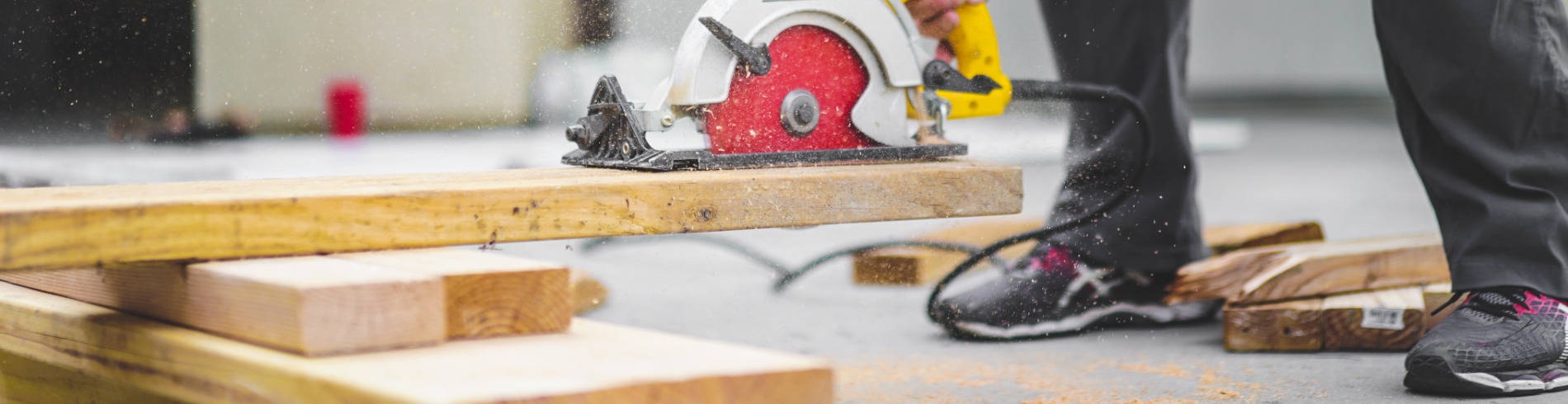 Construction worker cutting wood