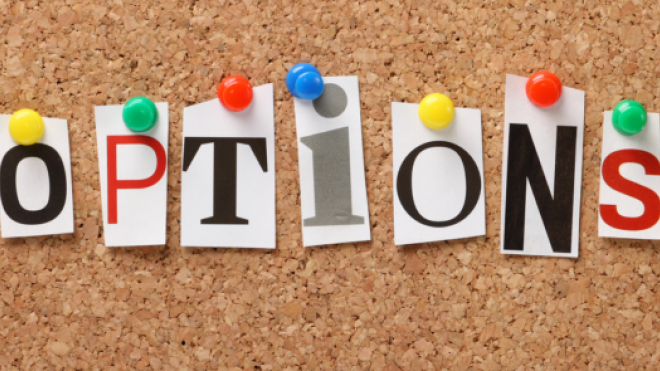 OPTIONS spelled with cut-out letters on a corkboard.