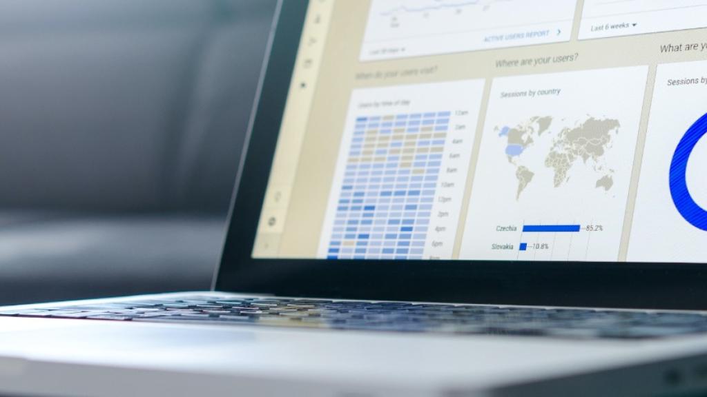 Laptop displaying charts and graphs on the screen.