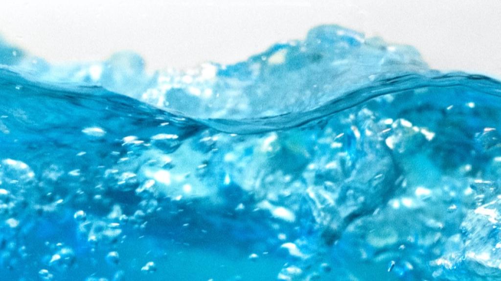 Blue water splash with bubbles and ripples.