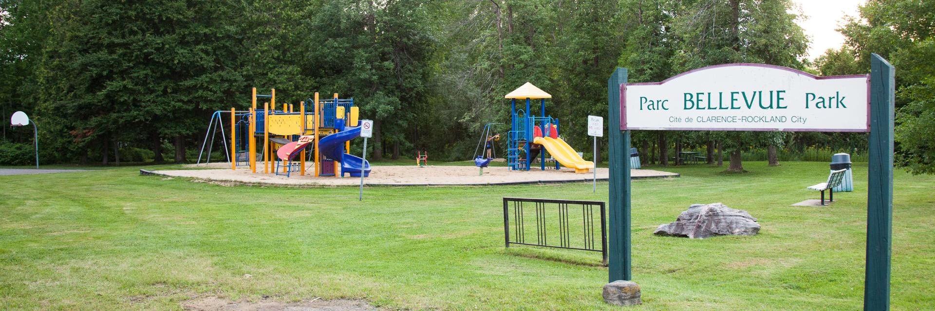 Playground with slides and climbing structures in a park.