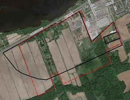 Aerial view of fields with overlay of red and black boundary lines.